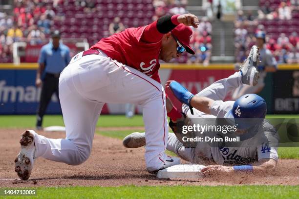 Donovan Solano of the Cincinnati Reds tags out Austin Barnes of the Los Angeles Dodgers at third base in the third inning at Great American Ball Park...