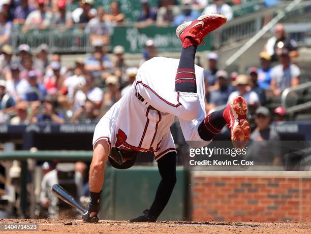 Dansby Swanson of the Atlanta Braves throws his feet in the air as he is hit by pitch for a RBI in the second inning against the San Francisco Giants...