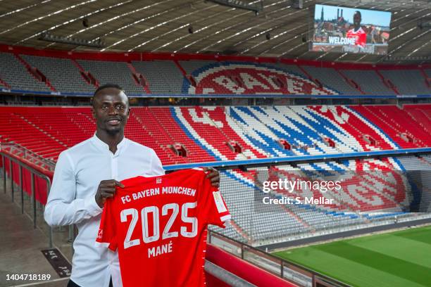 Sadio Mane poses inside the stadium with a jersey after his presentation as new player of FC Bayern München at Allianz Arena on June 22, 2022 in...