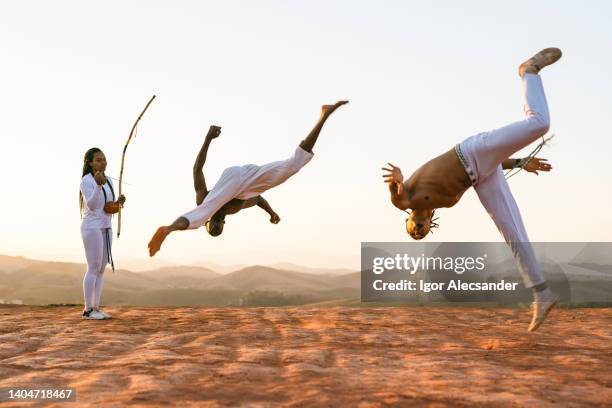 young capoeiristas floating in the air - arts martiaux stock pictures, royalty-free photos & images