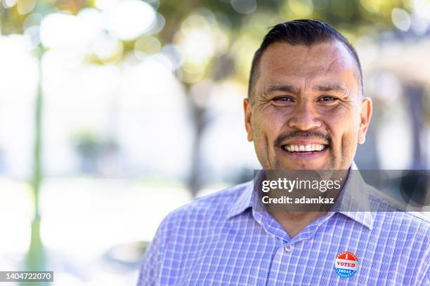 mexican man with i voted sticker - voting stock pictures, royalty-free photos & images