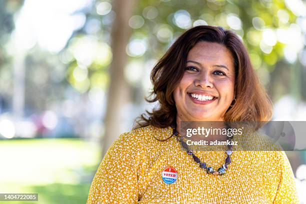 mexican woman with i voted sticker - vote sticker stock pictures, royalty-free photos & images