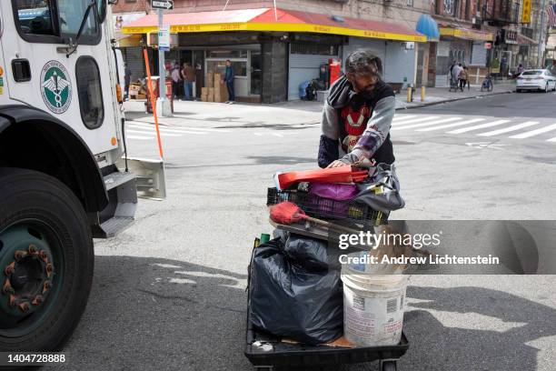 Homeless man, forced to dismantle their possessions by the New York City Department of Sanitation and police officers as part of a city sweep of...
