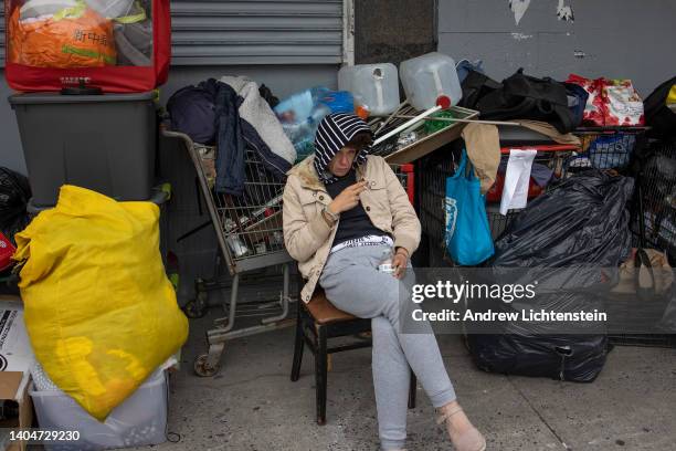 Homeless women, forced to dismantle their possessions by the New York City Department of Sanitation and police officers as part of a city sweep of...