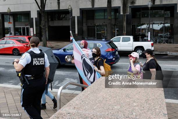 Transgender rights activists with Shutdown DC protest outside a "Our Bodies, Our Sports" rally for the 50th anniversary of Title IX at Freedom Plaza...