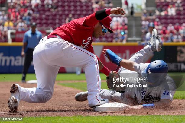 Donovan Solano of the Cincinnati Reds tags out Austin Barnes of the Los Angeles Dodgers at third base in the third inning at Great American Ball Park...