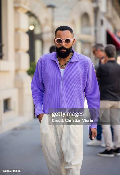 Guest is seen wearing purple shirt, beige pants outside Issey Miyake during Paris Fashion Week - Menswear Spring/Summer 2023 on June 23, 2022 in...