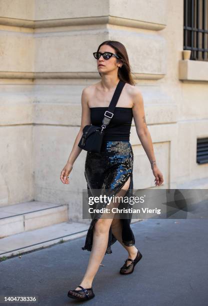 Guest is seen wearing glitter black skirt with slit, off shoulder top outside Issey Miyake during Paris Fashion Week - Menswear Spring/Summer 2023 on...