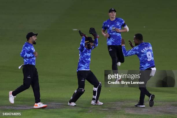 Mohammad Rizwan of Sussex Sharks celebrates with team mate Delray Rawlins after making a catch at The 1st Central County Ground on June 23, 2022 in...