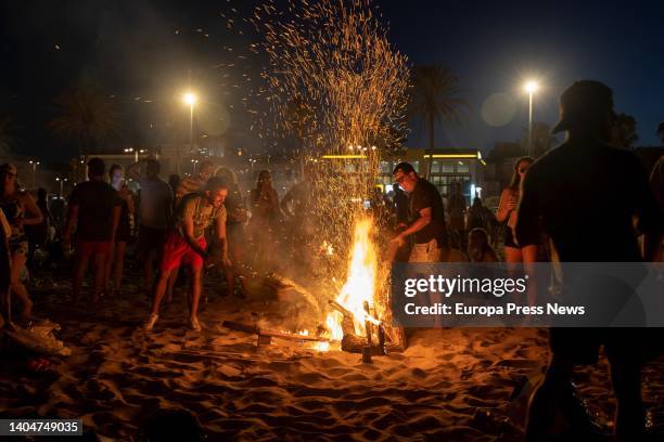 Hundreds of people in front of a bonfire on the Malvarrosa beach during the Night of San Juan, on 23 June, 2022 in Valencia, Valencian Community,...