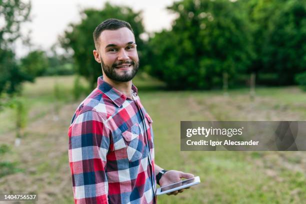 portrait of a young agronomist on the farm - young agronomist stock pictures, royalty-free photos & images