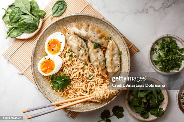 asian ramen noodle soup with dumplings, egg and parsley - miso sauce stock pictures, royalty-free photos & images