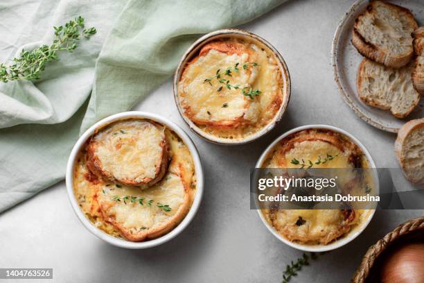 french homemade onion soup with cheese and bread. top view - onion soup stock pictures, royalty-free photos & images