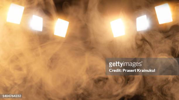 scene, stage lighting with gold colored spotlights and smoke - palco imagens e fotografias de stock