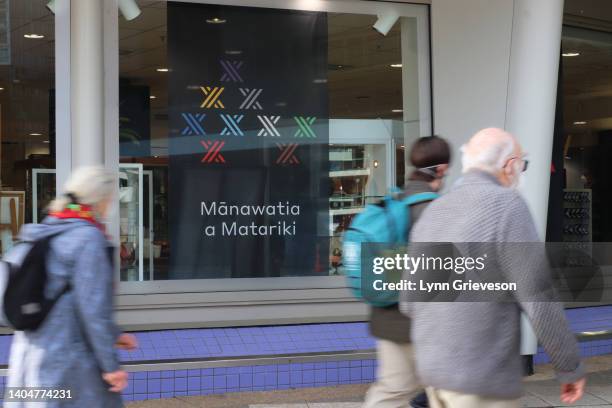 People walk past signage celebrating Matariki at the Te Papa National Museum on June 24, 2022 in Wellington, New Zealand. New Zealand is officially...