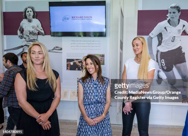 Yorba Linda, CA U.S. Olympic gold medalists: Courtney Mathewson, left, Janet Evans, center, and Kerri Walsh Jennings, view the new exhibit, Evening...
