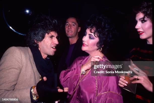 View of musician Keith Richards , actress actress Elizabeth Taylor , and her adoptive daughter, Maria Burton as they attend an unspecified event at...