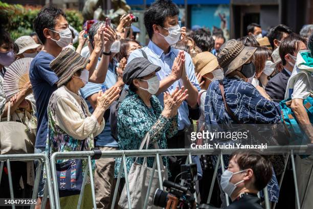 People cheer as Japanese Prime Minister Fumio Kishida speaks during a Liberal Democratic Party campaign rally on June 24, 2022 in Yokohama, Japan....