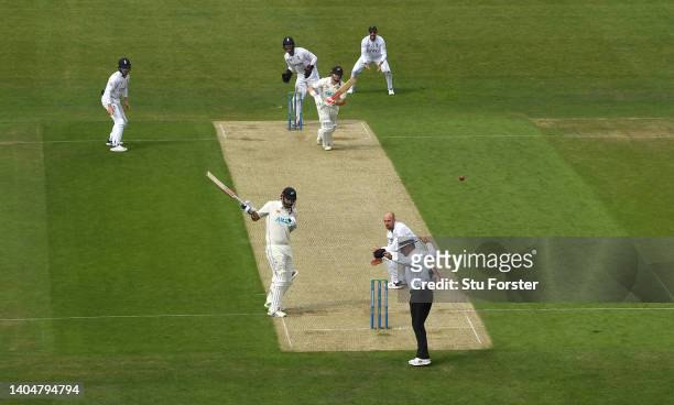 New Zealand batsman Henry Nicholls drives watched by Ben Foakes only to caught by Alex Lees via the bat of Daryl Mitchell at the non strikers end as...