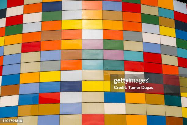 a modern shopping mall designed with colorful glass to attract the attention of potential customers. - psychedelic music stock pictures, royalty-free photos & images