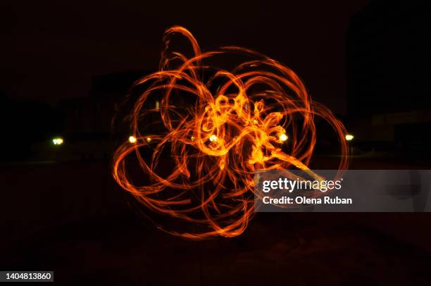 bent fire trace on black background. - sparkler stock photos et images de collection