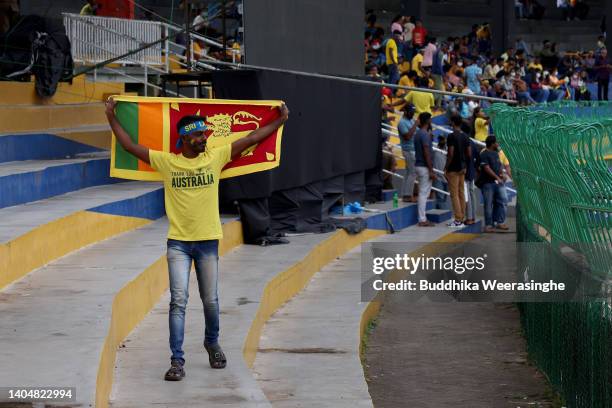 Sri Lankan cricket fan dressed in yellow t-shirt walks thanks to the Australia cricket team visit amid the Island's worst economic crisis prior to...