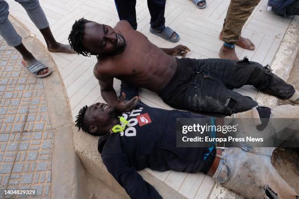 Two migrants rest after jumping the Melilla fence, June 24 in Melilla, Spain. The group of migrants is made up of more than 400 sub-Saharans, who...