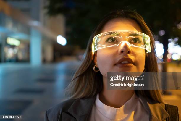 young woman with augmanted reality glasses - virtual reality glasses stockfoto's en -beelden