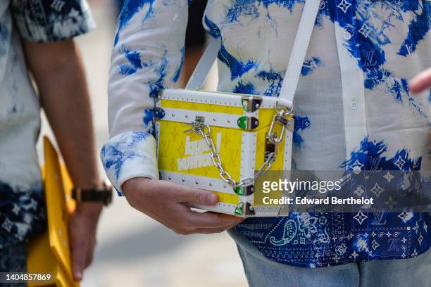 Guest wears a white and blue print pattern with LV monogram shirt from Louis Vuitton, a white and yellow shiny leather LV monogram print pattern...