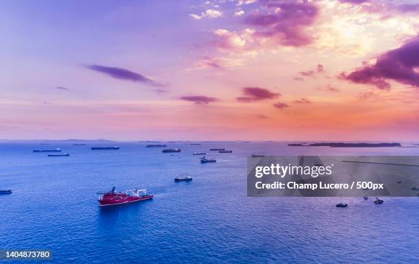 scenic view of sea against sky during sunset,singapore - singapore sky view stock pictures, royalty-free photos & images