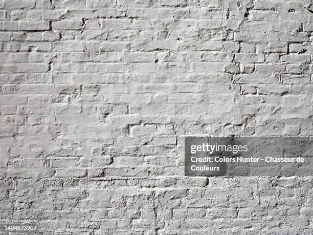 clean empty brick wall painted white and lit by the sun in london - painted brick house stock pictures, royalty-free photos & images