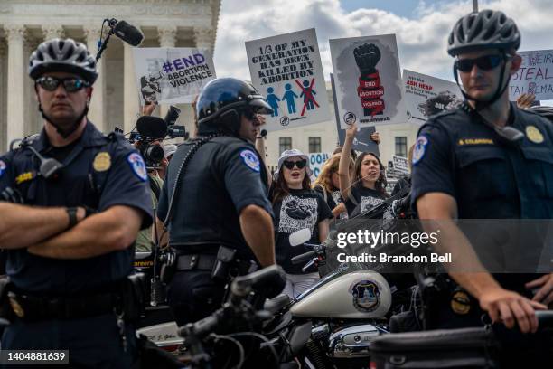 Demonstrators protest in front of the U.S. Supreme Court moments before the Dobbs v Jackson Women's Health Organization ruling on June 24, 2022 in...