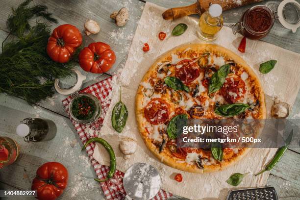 high angle view of pizza on table - pepperoni pizza overhead stock pictures, royalty-free photos & images