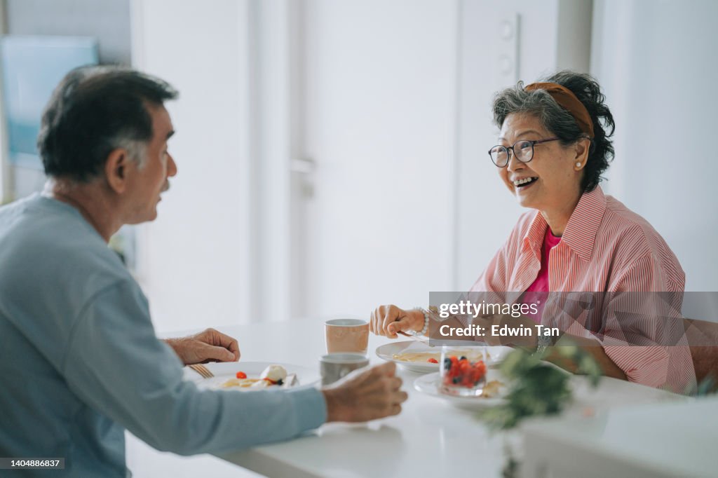 Asian chinese senior couple enjoying breakfast during weekend morning
