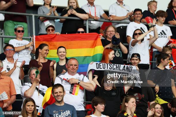Fans show their support as they display a rainbow flag from the stands prior to the Women's International friendly match between Germany and...
