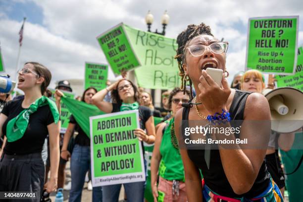 Abortion rights demonstrator Elizabeth White leads a chant in response to the Dobbs v Jackson Women's Health Organization ruling in front of the U.S....