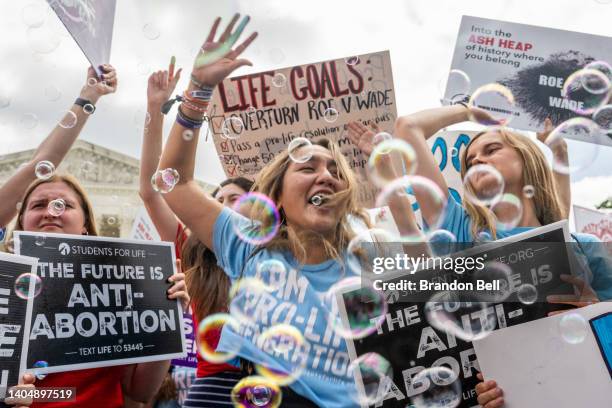 Anti-abortion activists celebrate in response to the Dobbs v Jackson Women's Health Organization ruling in front of the U.S. Supreme Court on June...