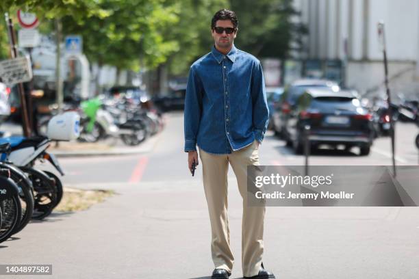 Marc Forne seen wearing a black sunglasses from Bottega Veneta, a blue denim blouse shirt, a beige pants and black leather shoes, outside the Solid...