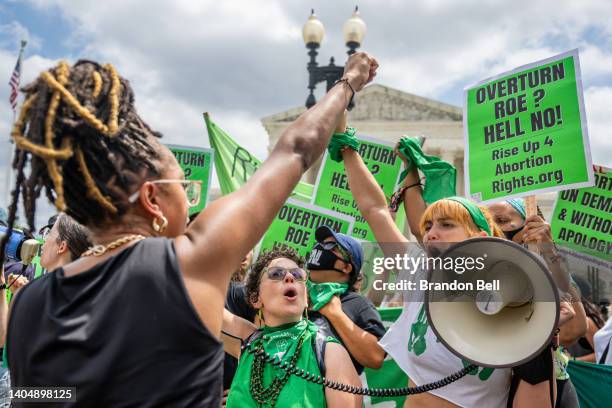 Abortion rights demonstrator Elizabeth White leads a chant in response to the Dobbs v Jackson Women's Health Organization ruling in front of the U.S....