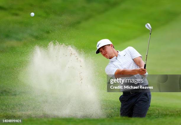 Cameron Champ of the United States plays a shot from a bunker on the 18th hole during the second round of Travelers Championship at TPC River...