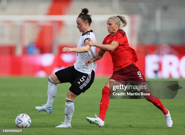 Marina Hegering of Germany is challenged by Ana-Maria Crnogorcevic of Switzerland during the Women's International friendly match between Germany and...