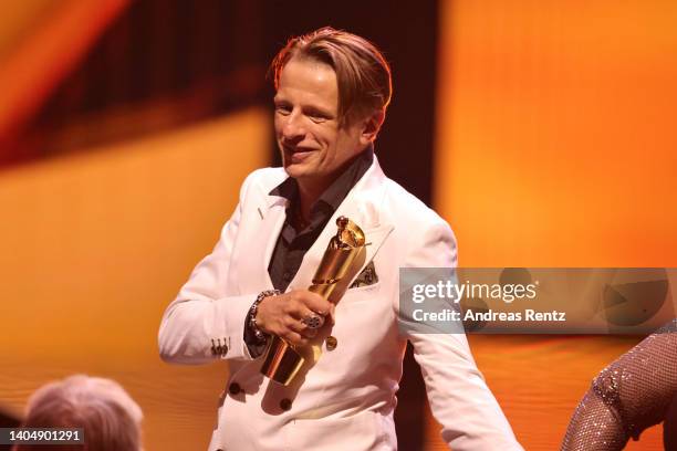 Winner of the Award for Best Supporting Actor Alexander Scheer on stage the 72nd Lola - German Film Award show at Palais am Funkturm on June 24, 2022...