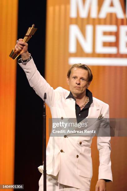 Winner of the Award for Best Supporting Actor Alexander Scheer on stage the 72nd Lola - German Film Award show at Palais am Funkturm on June 24, 2022...