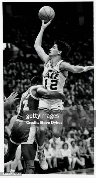 John Stockton of the Utah Jazz drives to the basket on Earvin "Magic" Johnson of the Los Angeles Lakers during an NBA basketball game circa 1988 at...