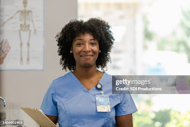 cheerful female orthopedist smiles for camera - independent record label stock pictures, royalty-free photos & images