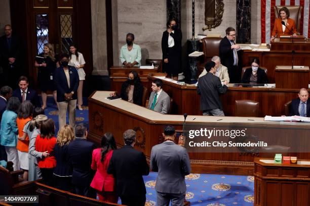 Democratic lawmakers put their arms around one another as Speaker of the House Nancy Pelosi announces the final vote count for the Bipartisan Safer...