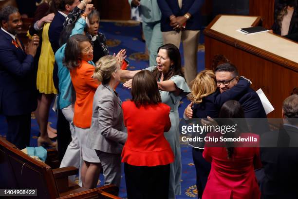 Democratic members of the House of Representatives cheer and embraces after the Bipartisan Safer Communities Act passed in the House Chamber on June...