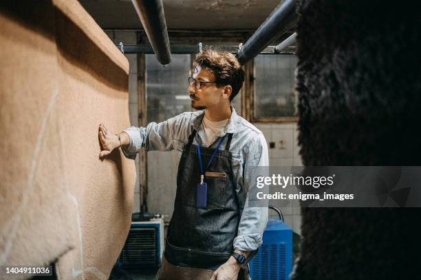 man working in a carpet laundry - wet carpet stock pictures, royalty-free photos & images