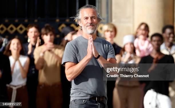 French fashion designer, Pierre Maheo acknowledges the audience at the end of the Officine Generale Menswear Spring Summer 2023 show as part of Paris...