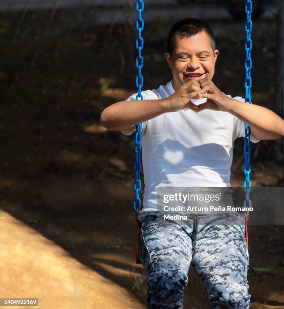 making a heart with your hands - autistic adult imagens e fotografias de stock